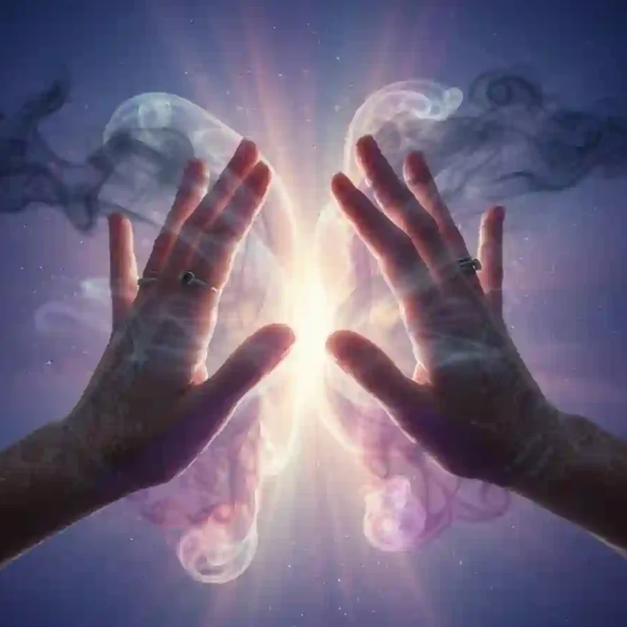 Spiritual hands clearing away dark energy to highlight the role of emotional intelligence in manifestation.