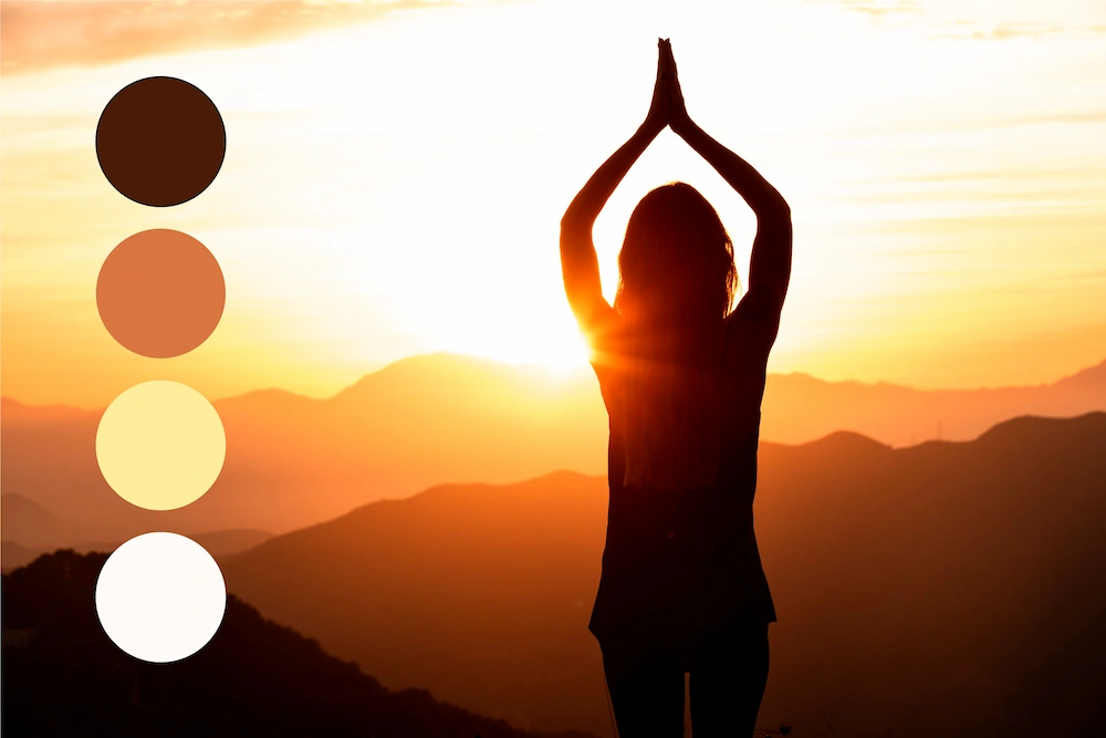 A woman in a sun-salutation silhouette representing duality and shadow work for 2/2 manifestation.