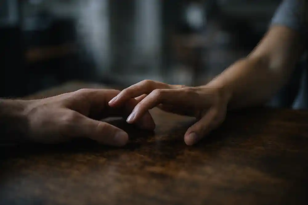 A woman avoiding eye contact with her partner due to a somatic glitch in the 222 portal aftermath.