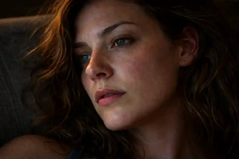 A gritty, high-detail photograph of a woman’s reflective face, illustrating 777 manifestation method for marriage and subconscious pattern resetting.