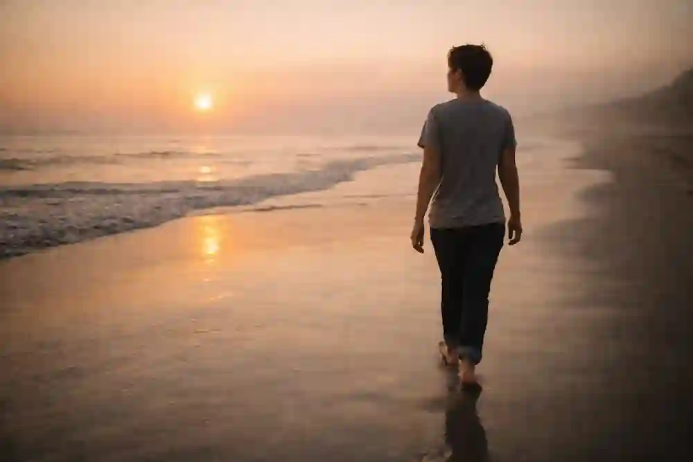 A person walking thoughtfully along a sunset beach, symbolizing their final reflection and closing thoughts on the 777 manifestation method for a specific person