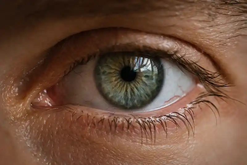 Detailed close-up of an eye with messy eyelashes and visible capillaries, highlighting the 7 hidden blocks killing love manifestation.