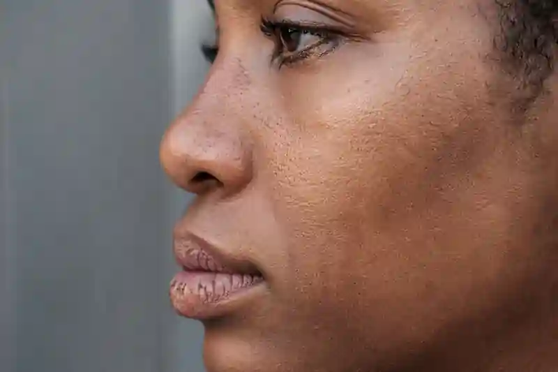 10K UHD photo of a face with uneven skin tone and natural texture, showing the calm state required for love manifestation.