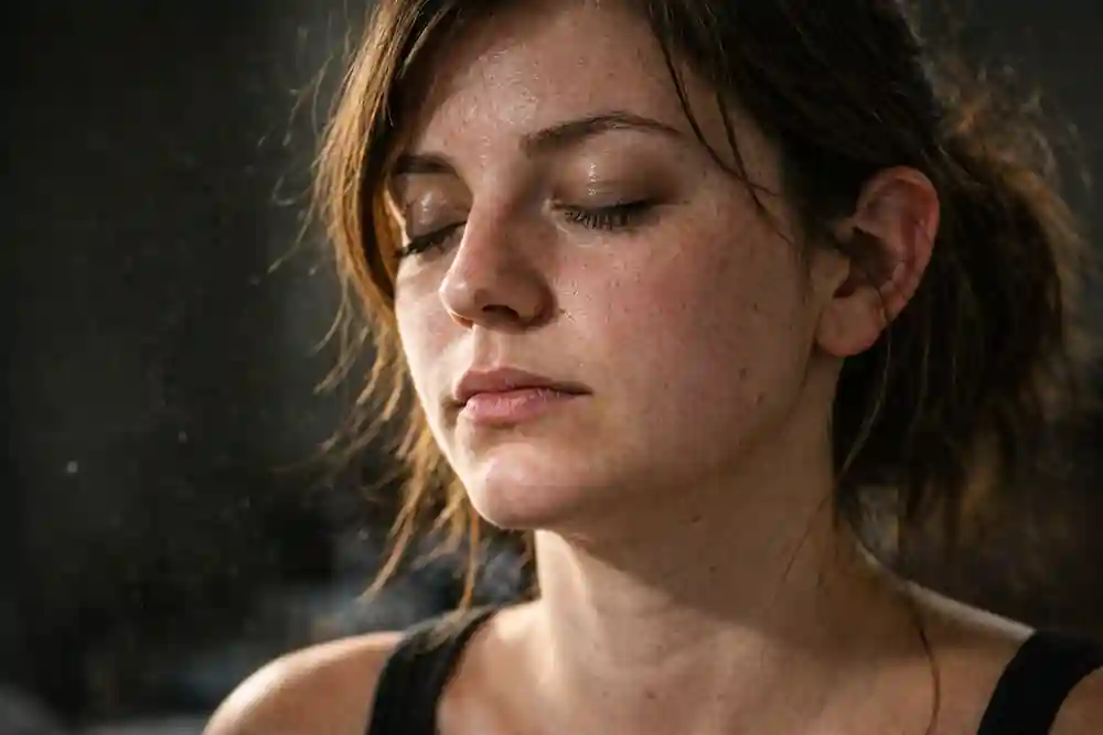 A high-detail portrait of a young woman with messy hair and visible pores, eyes closed, focusing on love energy.