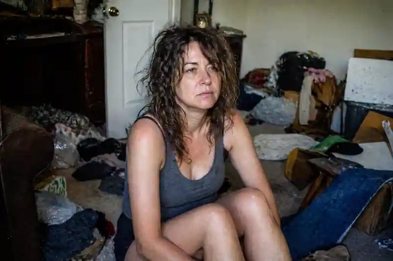 A 35mm candid shot of a woman sitting on an unmade bed, using the 777 alignment method for dopamine rewiring.