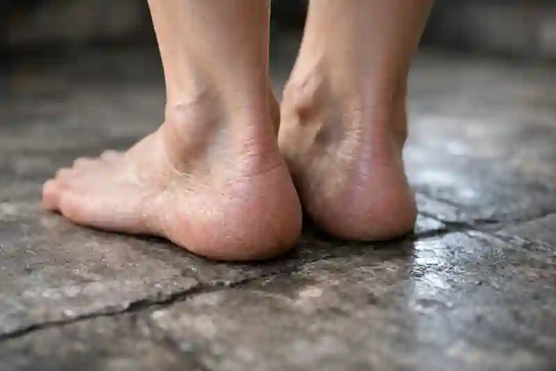 A raw photo of bare feet on textured ground, showing goosebumps for 777 manifestation method money somatic alignment.
