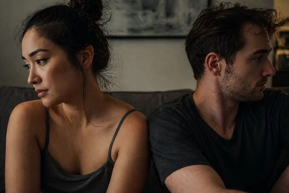 A candid, raw shot of a couple in a moment of relationship tension involving the 🌓 meaning in love and text.