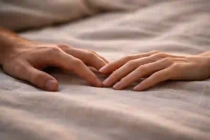 A raw, intimate shot of two people's hands near a window, linking moon phase soulmate test and wealth stability.