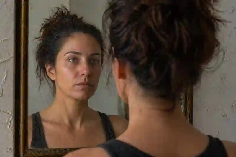 A raw, candid photo of a woman looking into a mirror with a non-perfect lip alignment and visible skin texture, representing frequency stacking and waxing crescent moon emoji codes.