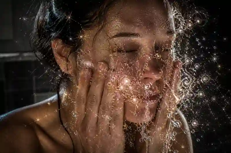 Raw photograph of a woman splashing water with fractal light droplets, representing energy detox and Full Moon symptoms spiritual meaning.